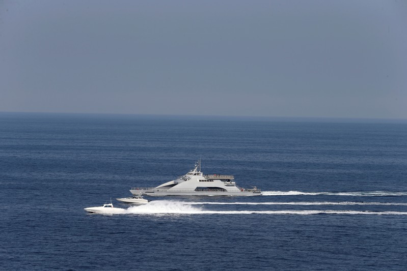 FILE PHOTO: Iranian Revolutionary Guards speed boats are seen near the USS John C. Stennis CVN-74 as it makes its way to gulf through strait of Hormuz
