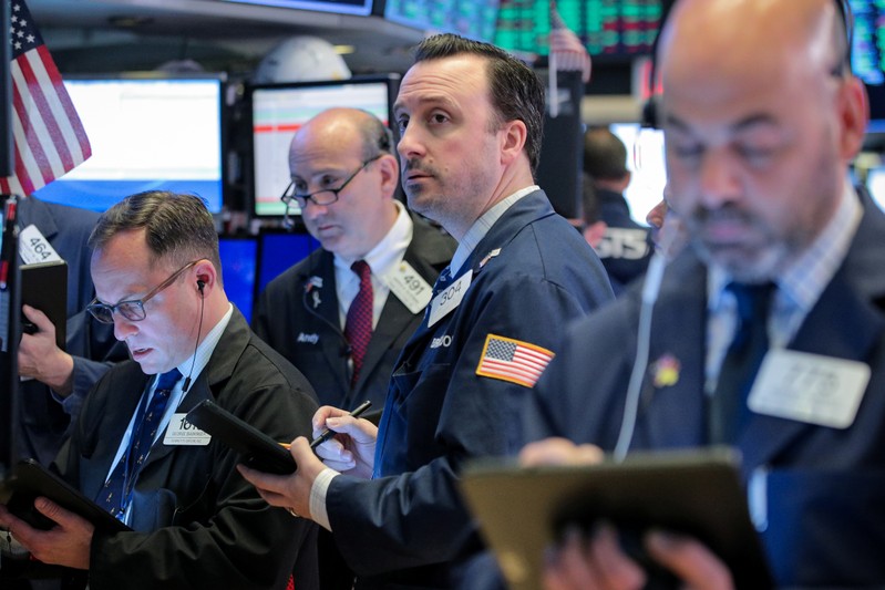 Traders work on the floor at the NYSE in New York