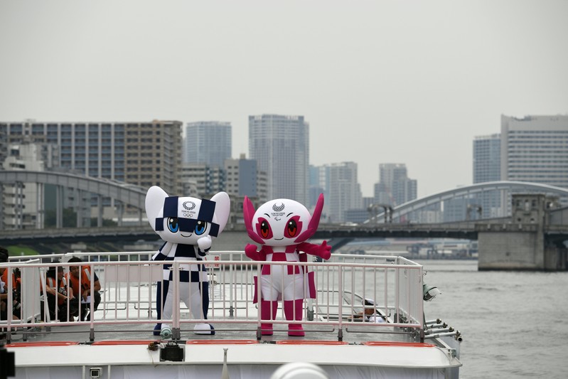 Tokyo 2020 Olympics Games mascots, Miraitowa and Someity ride on a boat during their debut event of water parade in Tokyo