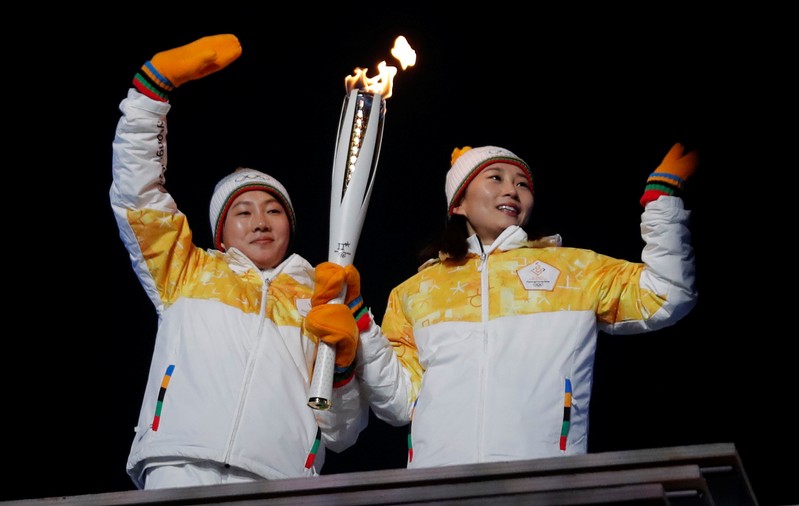 FILE PHOTO: Hockey players from the unified Korean team carry the Olympic flame during the opening ceremony at the Pyeongchang 2018 Winter Olympics