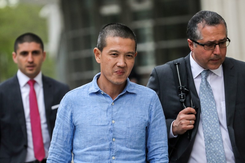 FILE PHOTO: Ex-Goldman Sachs banker Roger Ng (center) and his lawyer leave the federal court in New York