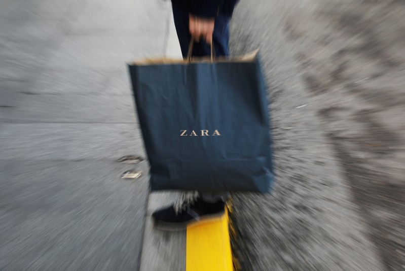 FILE PHOTO: A mans hold a Zara shopping bag outside a Zara store, an Inditex brand, in central Madrid