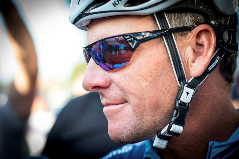 FILE PHOTO: Cyclist Lance Armstrong of the US speaks to journalists as he leaves his bus before taking part in Geoff Thomas's 'One Day Ahead' charity event during a stage of the 102nd Tour de France cycling race from Muret to Rodez