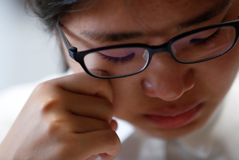 Miwa Moriya cries while she speaks during an interview with Reuters at her house in Yokohama
