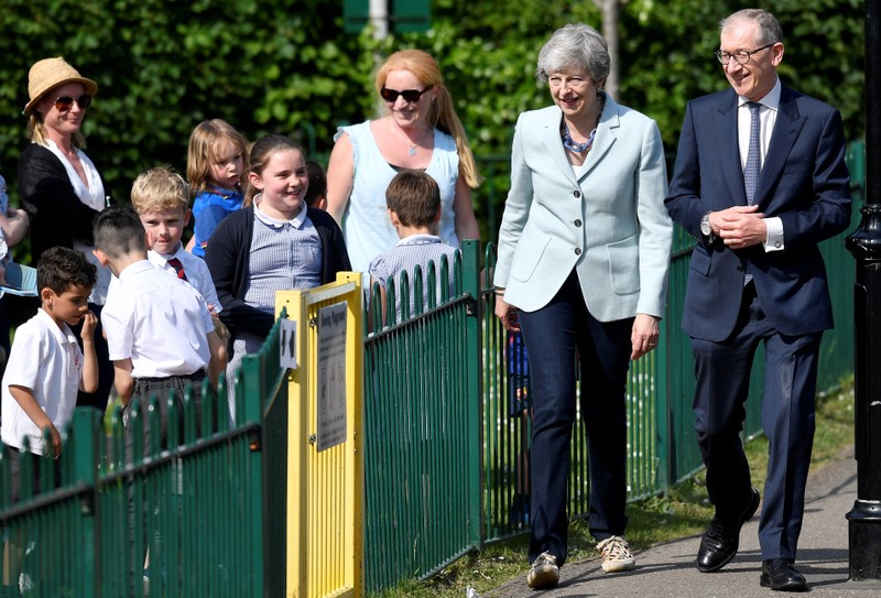 Britain's Prime Minister Theresa May and her husband Philip arrive to vote in the European Parliament Elections, in Sonning