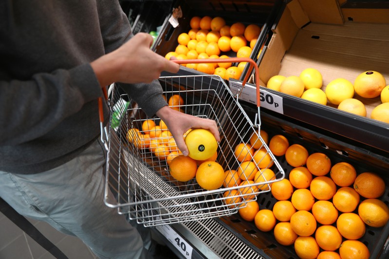 A shopper loads a basket in a supermarket in London