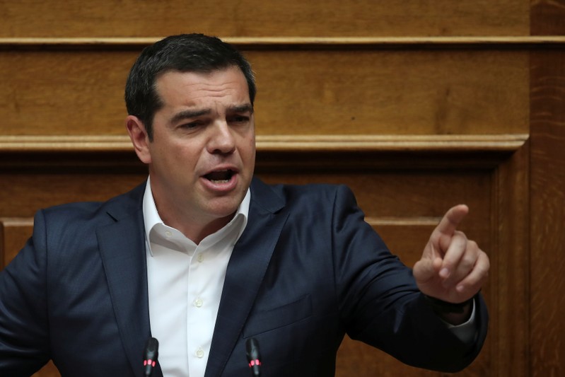 Greek PM Tsipras addresses lawmakers during a parliamentary session before a vote on tax breaks in Athens