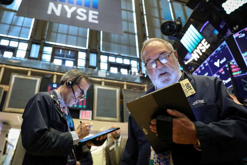 Traders work on the floor at the NYSE in New York