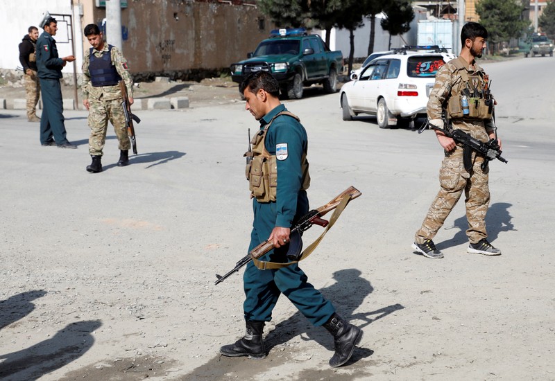 Afghan security forces keep watch outside a mosque after a blast in Kabul