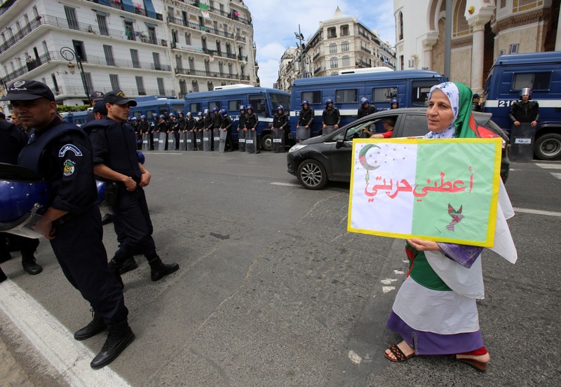 A demonstrator carries a banner during an anti-government protest in Algiers