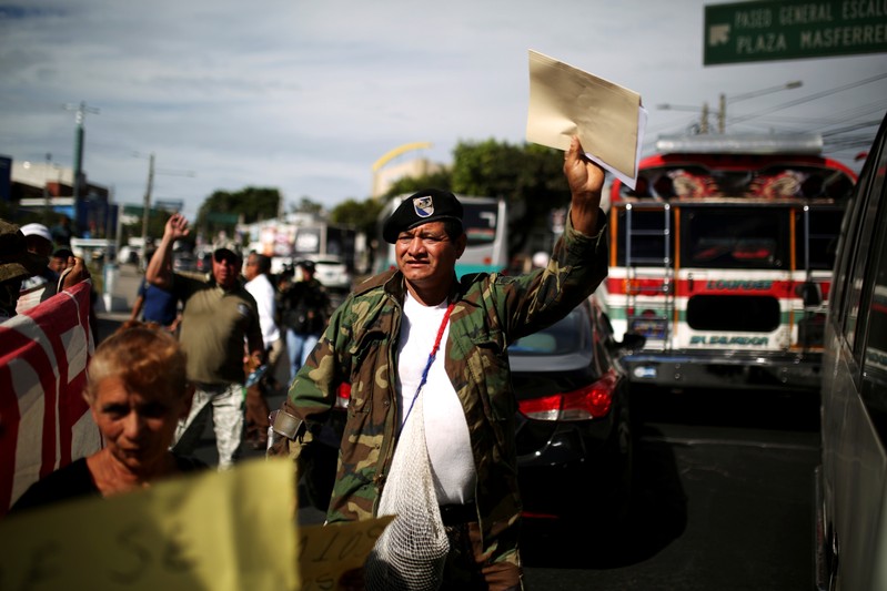 FILE PHOTO: Civil war veterans protest during the commemoration of the 26th anniversary of the signing of the peace accords in San Salvador