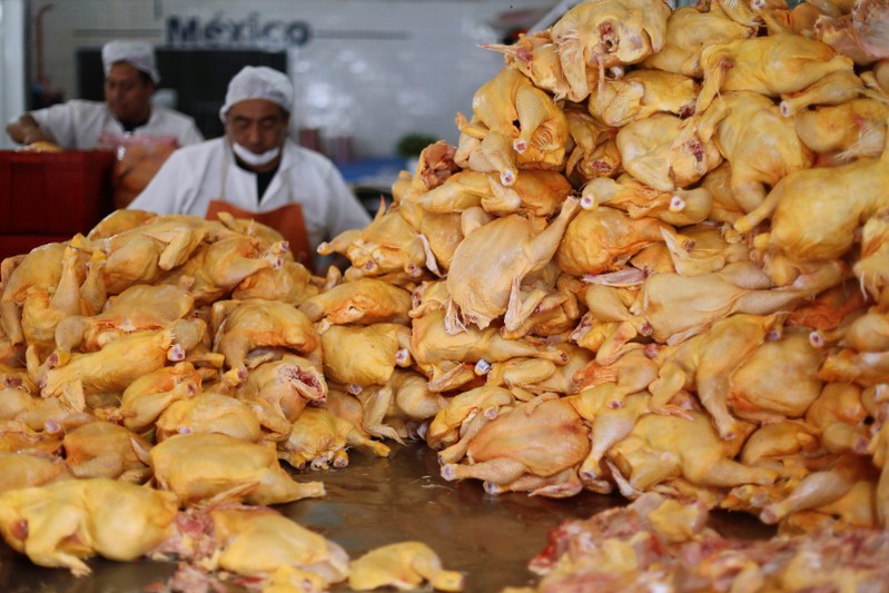 FILE PHOTO: Butchers cut up chickens in a butcher shop in downtown Mexico City