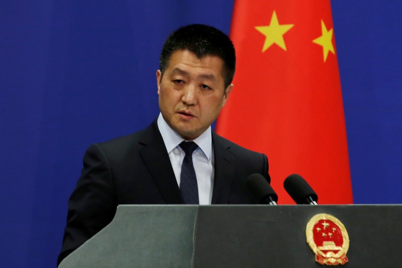 Chinese Foreign Ministry spokesman Lu Kang answers questions about a major bus accident in North Korea, during a news conference in Beijing