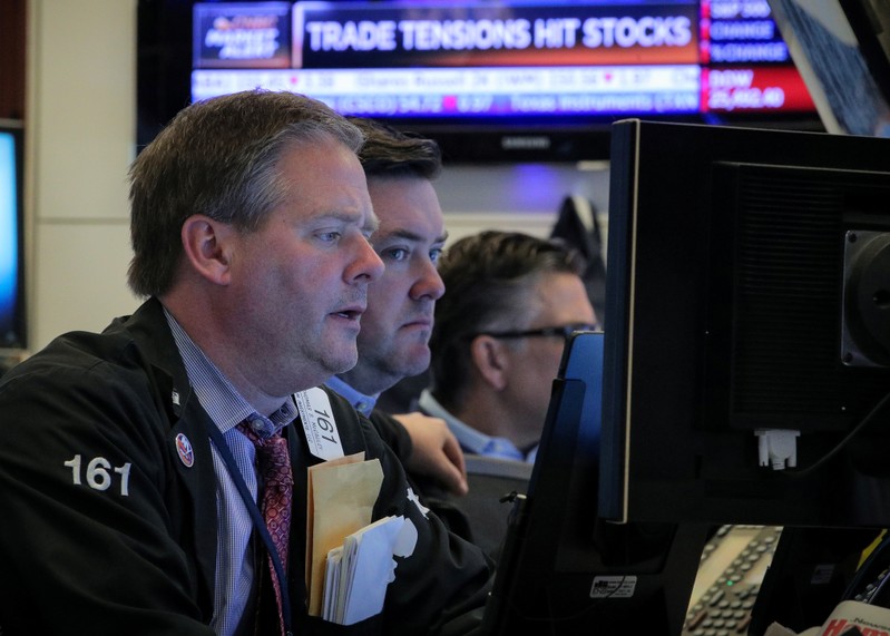 Traders work on the floor at the NYSE in New York