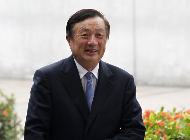 FILE PHOTO: Huawei CEO and founder Ren Zhengfei walks inside Huawei's headquarters in Shenzhen