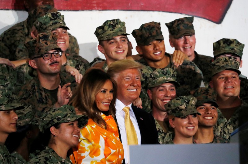 U.S. President Donald Trump and first lady Melania Trump take photos with military personnel aboard the USS Wasp as they participate in a Memorial Day Address in Yokosuka