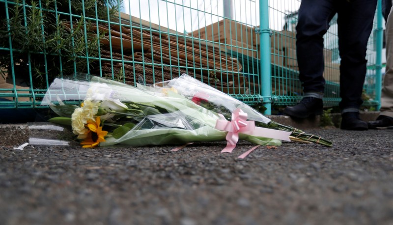 Flowers are offered at the site where a stabbing occured in Kawasaki city