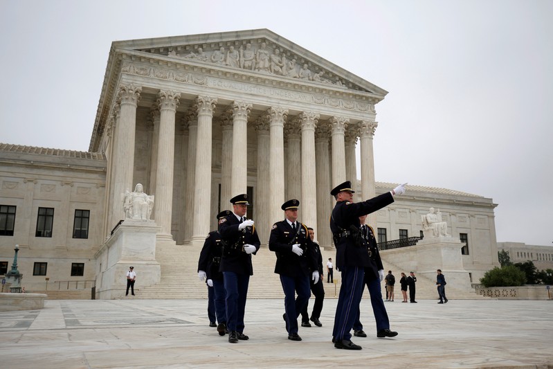 FILE PHOTO: Police officers walk on the plaza of the Supreme Court in Washington