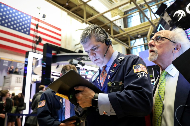 Traders work on the floor at the NYSE in New York