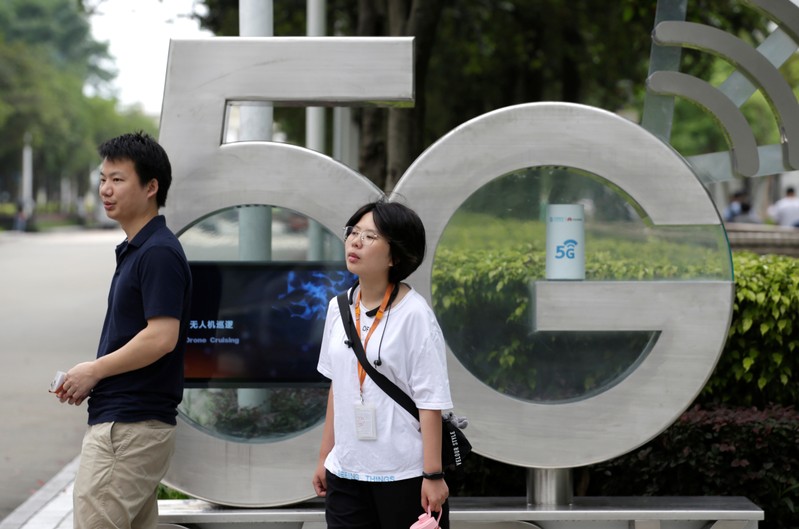 Employees wait for a shuttle bus at a 5G testing park at Huawei's headquarters in Shenzhen