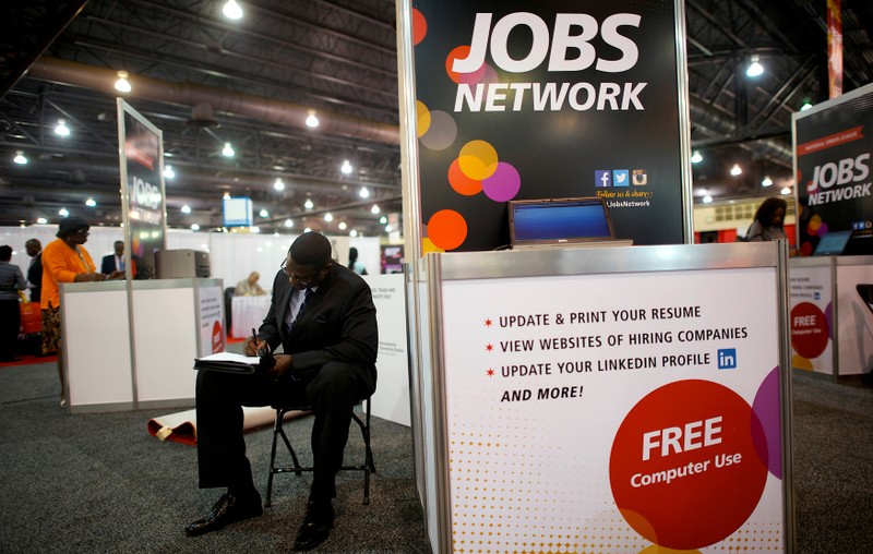 FILE PHOTO: File photo of a job-seeker completing an application at a career fair in Philadelphia