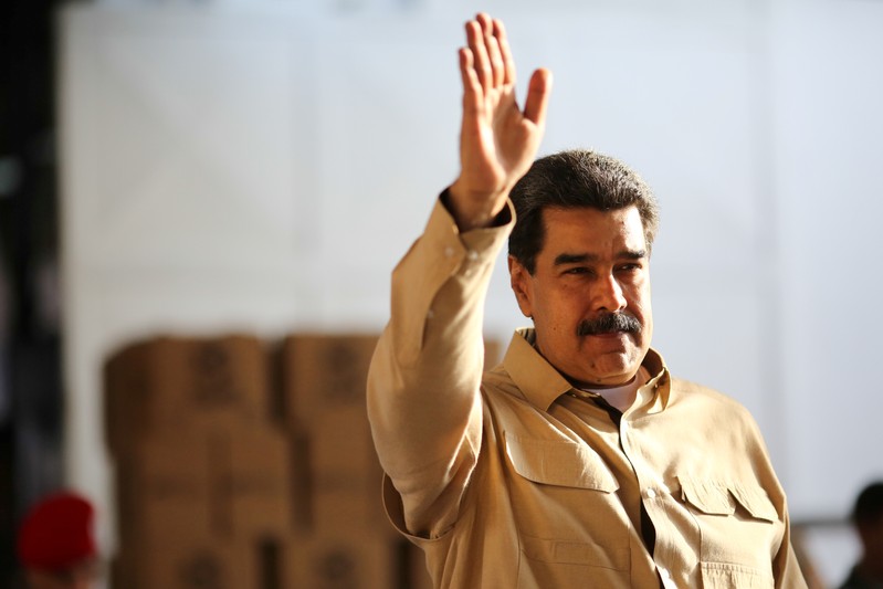 FILE PHOTO: Venezuela's President Nicolas Maduro waves during his visit to a packing center of the CLAP (Local Committees of Supply and Production) program, a Venezuelan government handout of basic food supplies, in Caracas