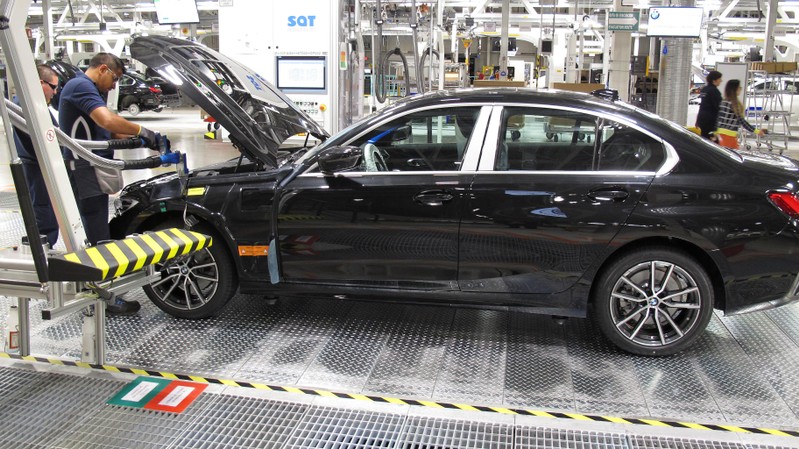 Employees work on a BMW 3 Series car during a media tour at the new plant of German automaker BMW in San Luis Potosi