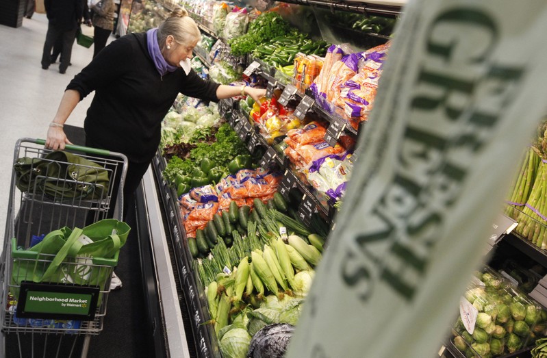 A shopper looks through the produce section in a newly opened Walmart Neighborhood Market in Chicago
