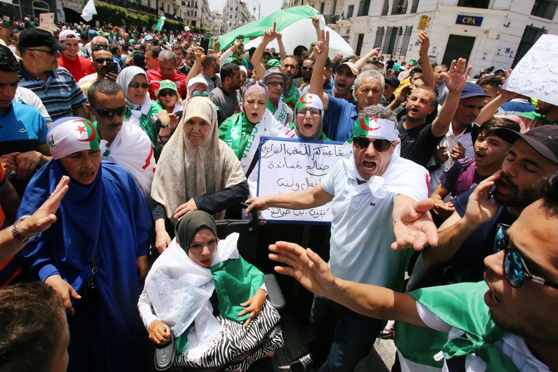 Demonstrators chant slogans during a protest demanding the removal of the ruling elite in Algiers