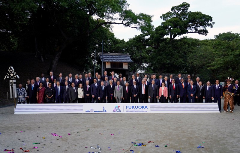 Japan's Finance Minister Taro Aso poses with delegation members for a family photo during the G20 finance ministers and central bank governors meeting, in Fukuoka