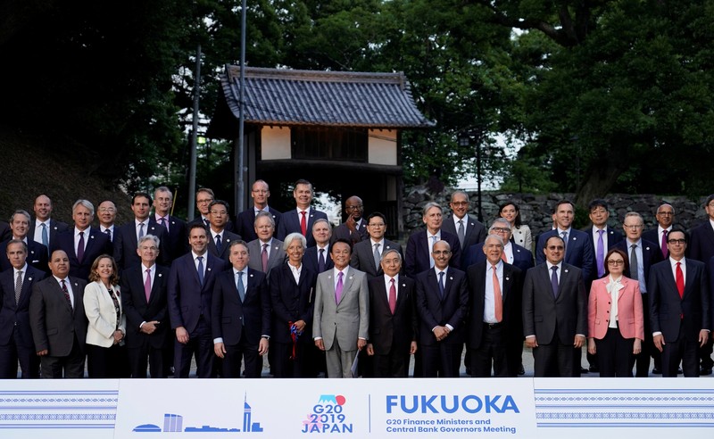 Japan's Finance Minister Taro Aso poses next to IMF Managing Director Christine Lagarde and Bank of Japan Governor Haruhiko Kuroda for a family photo during the G20 finance ministers and central bank governors meeting, in Fukuoka