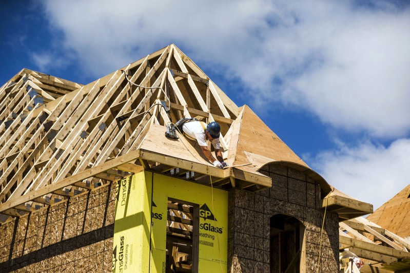 A construction worker works on a new house being built in a suburb located north of Toronto