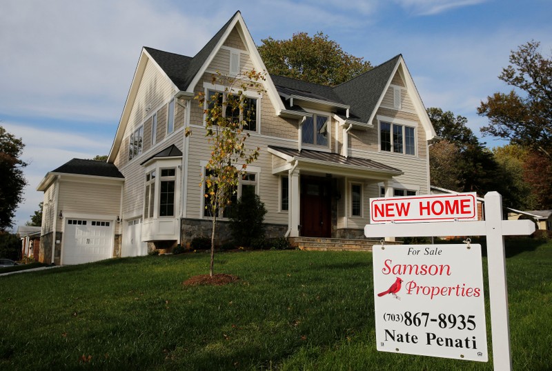 FILE PHOTO - A real estate sign advertising a new home for sale is pictured in Vienna, Virginia