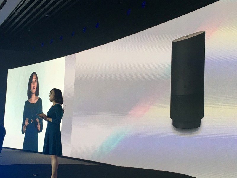 A member of staff from Alibaba Group introduces the company's newly released cut-price voice assistant speaker Tmall Genie during a press conference in Beijing