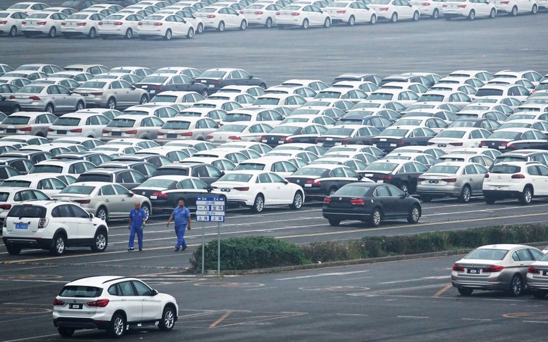 FILE PHOTO: Newly manufactured cars are seen at the automobile terminal in the port of Dalian, Liaoning