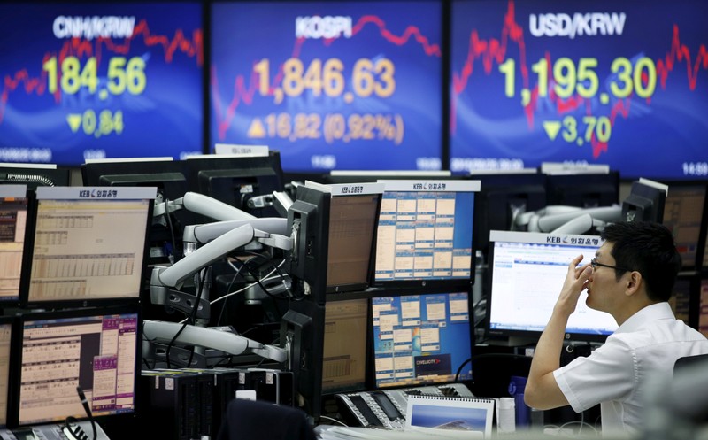 FILE PHOTO: A currency dealer works at a dealing room of a bank in Seoul