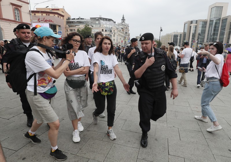 Policemen escort participants of a rally in support of Russian investigative journalist Ivan Golunov in Moscow