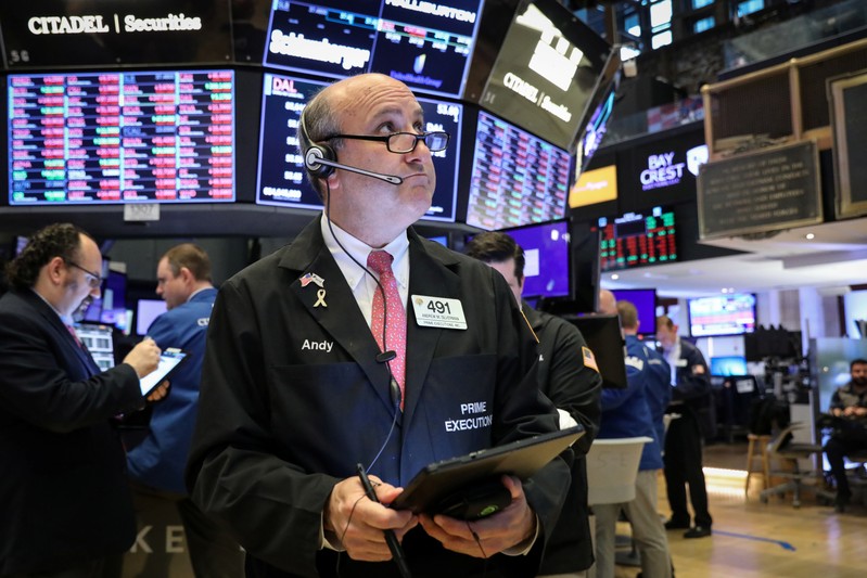 Traders work on the floor at the NYSE in New York