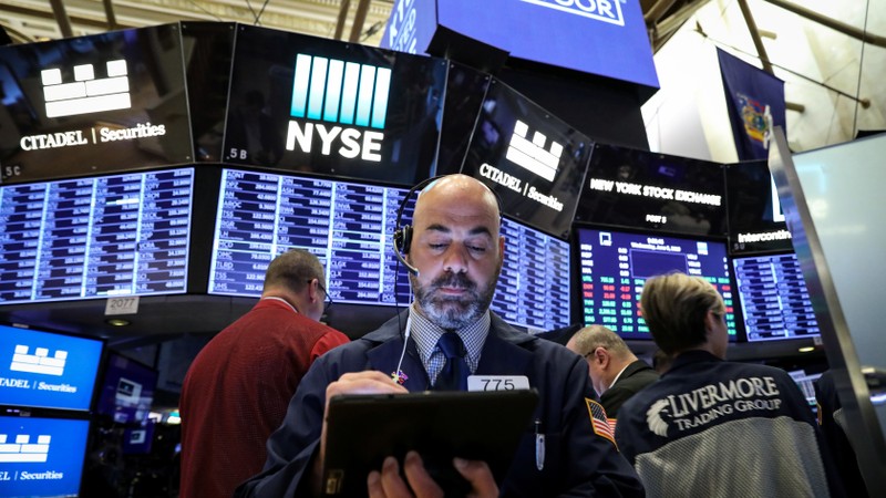 Traders work on the floor at the NYSE in New York