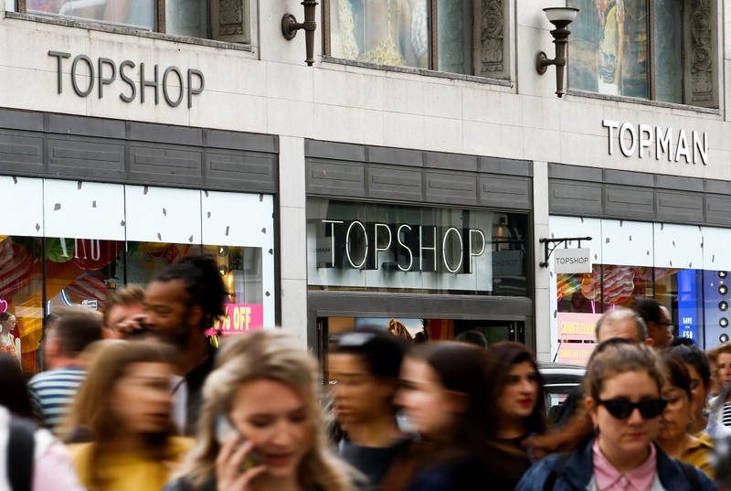 FILE PHOTO: People walk past a Topshop and Topman store, owned by Arcadia Group, in central London