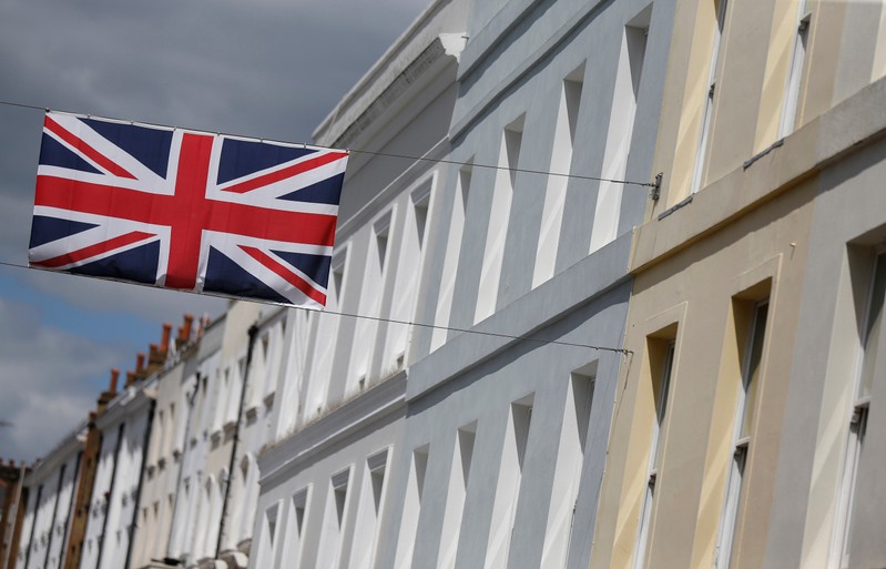 FILE PHOTO: A Union flag hangs across a street of houses in London