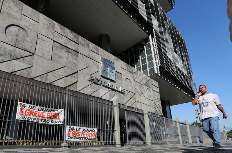 A man walks in front of the Brazil's state-run Petrobras oil company headquarters, during a general strike against the government's pension plan in Rio de Janeiro