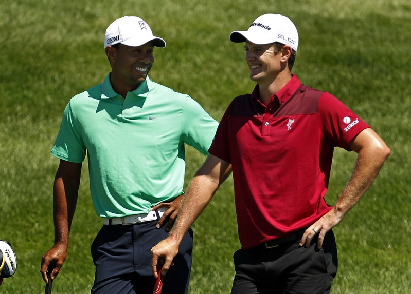 Woods of the U.S. jokes with Rose of England during the third round of the Barclays PGA golf tournament in Jersey City