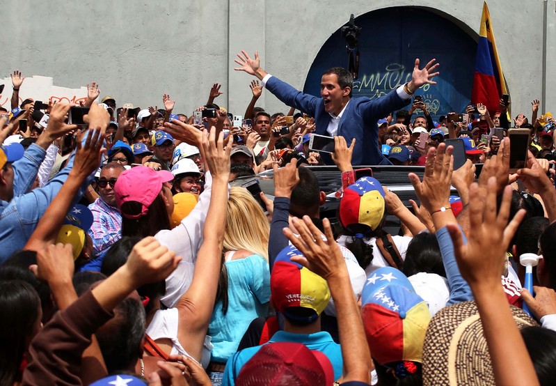 Venezuelan opposition leader Juan Guaido, who many nations have recognised as the country's rightful interim ruler, greets supporters after delivering a speech, in Merida