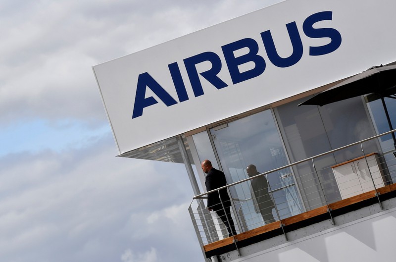 FILE PHOTO: A man stands at an Airbus trade pavilion at Farnborough International Airshow in Farnborough, Britain