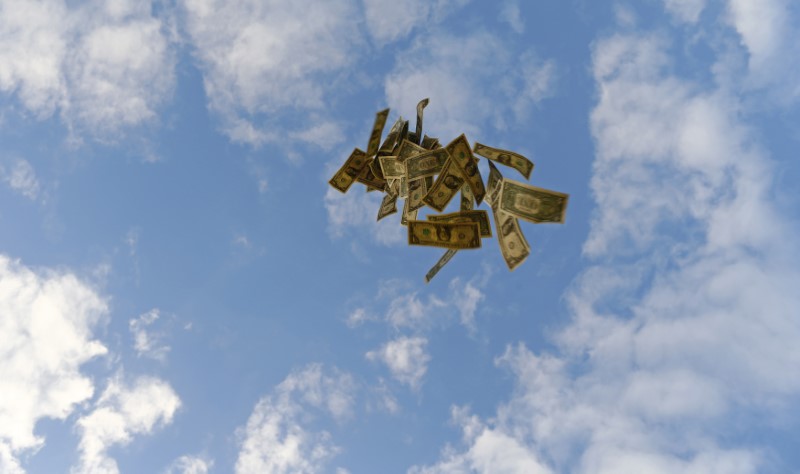 U.S. one dollar bills blow in this photo illustration. REUTERS/Marcelo Del Pozo