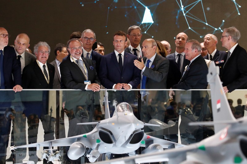 French President Emmanuel Macron, listens to Eric Trappier, Chairman and CEO of Dassault Aviation, during a visit at the 53rd International Paris Air Show at Le Bourget Airport