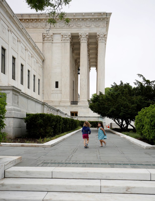 FILE PHOTO: Children walk at the Supreme Court before decisions are released for the term in Washington