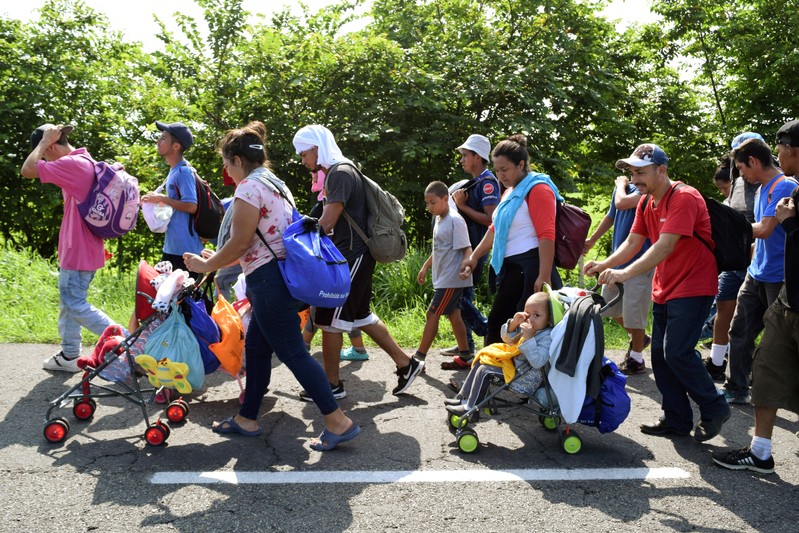 Migrants from Central America walk on a highway during their journey towards the United States, in Ciudad Hidalgo