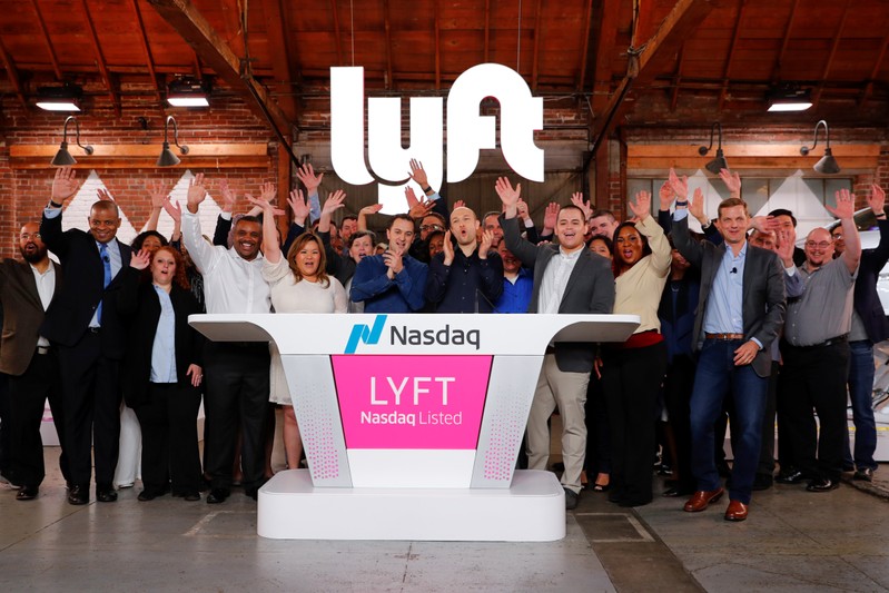 FILE PHOTO: Lyft President John Zimmer and CEO Logan Green applaud as Lyft lists on the Nasdaq at an IPO event in Los Angeles